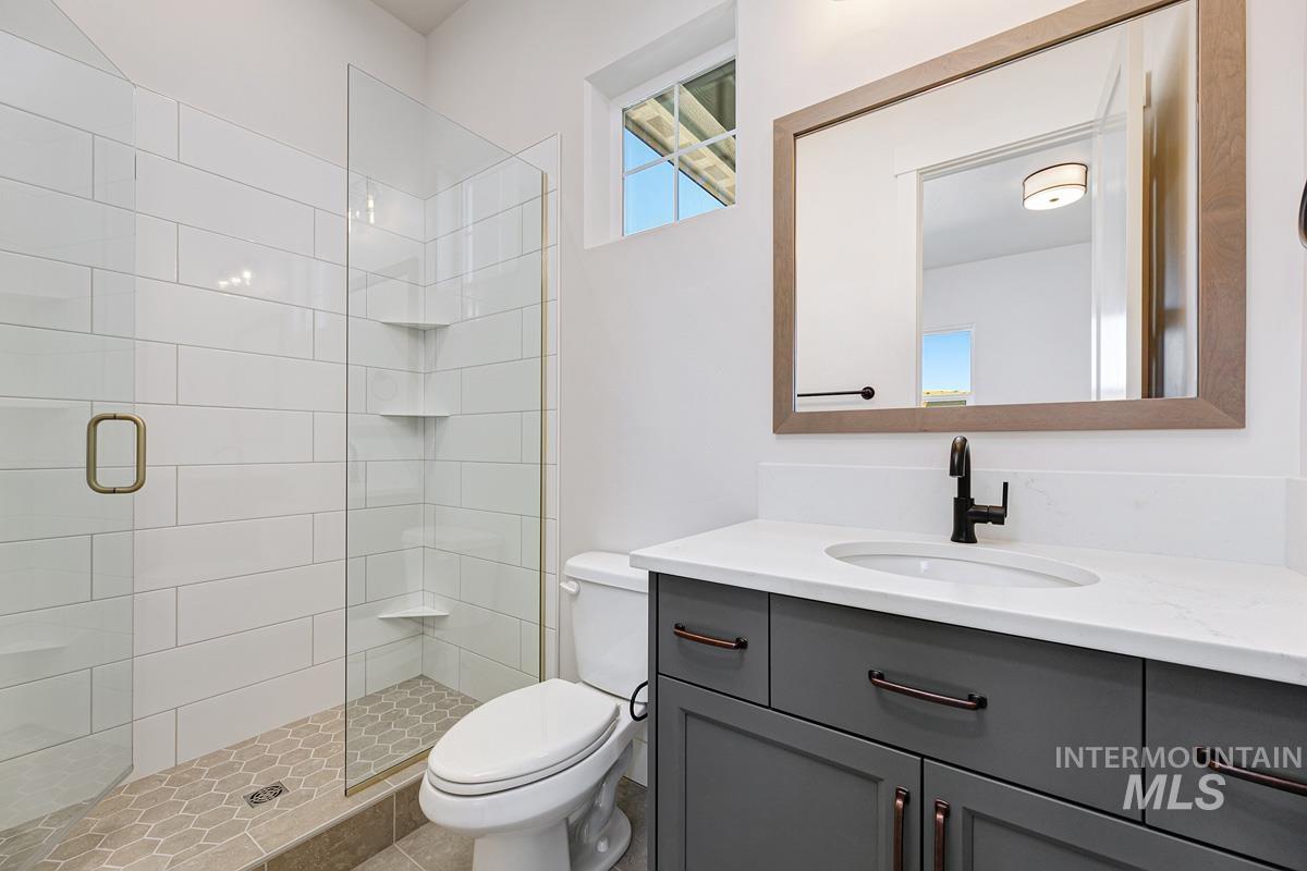 Full bathroom featuring vanity and a stall shower