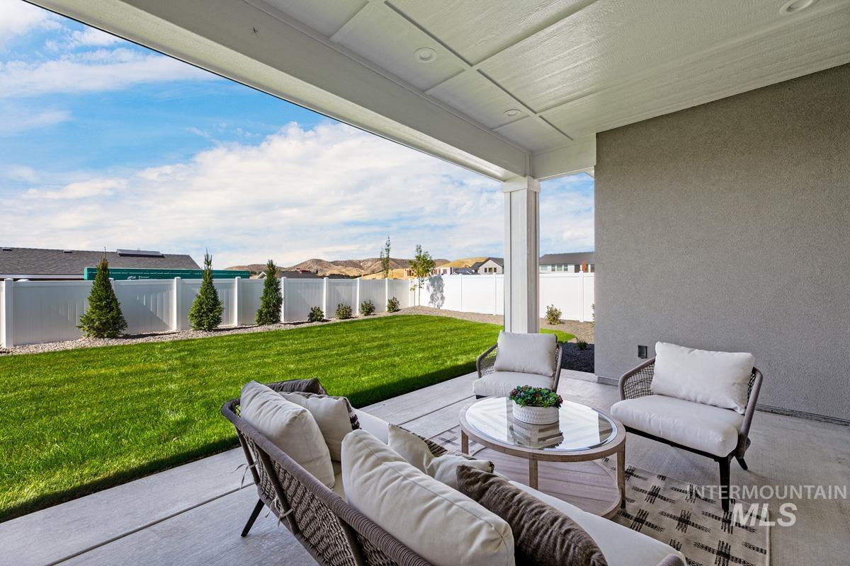 Fenced backyard featuring outdoor lounge area and a patio