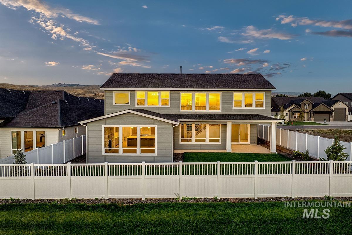 Rear view of house with a patio and a fenced backyard
