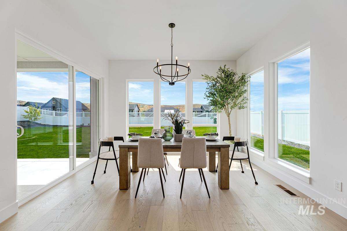 Sunroom with a chandelier and a residential view