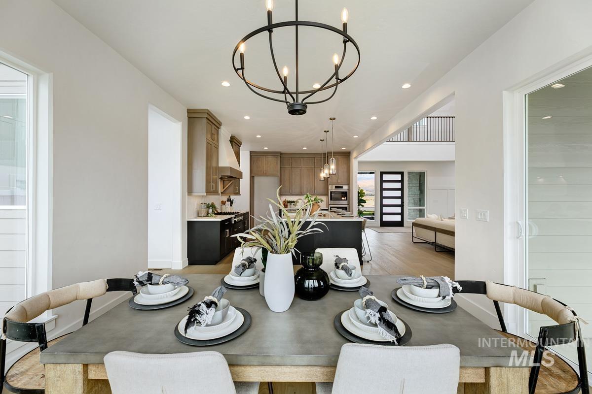Dining area with recessed lighting, a chandelier, and light wood-style flooring