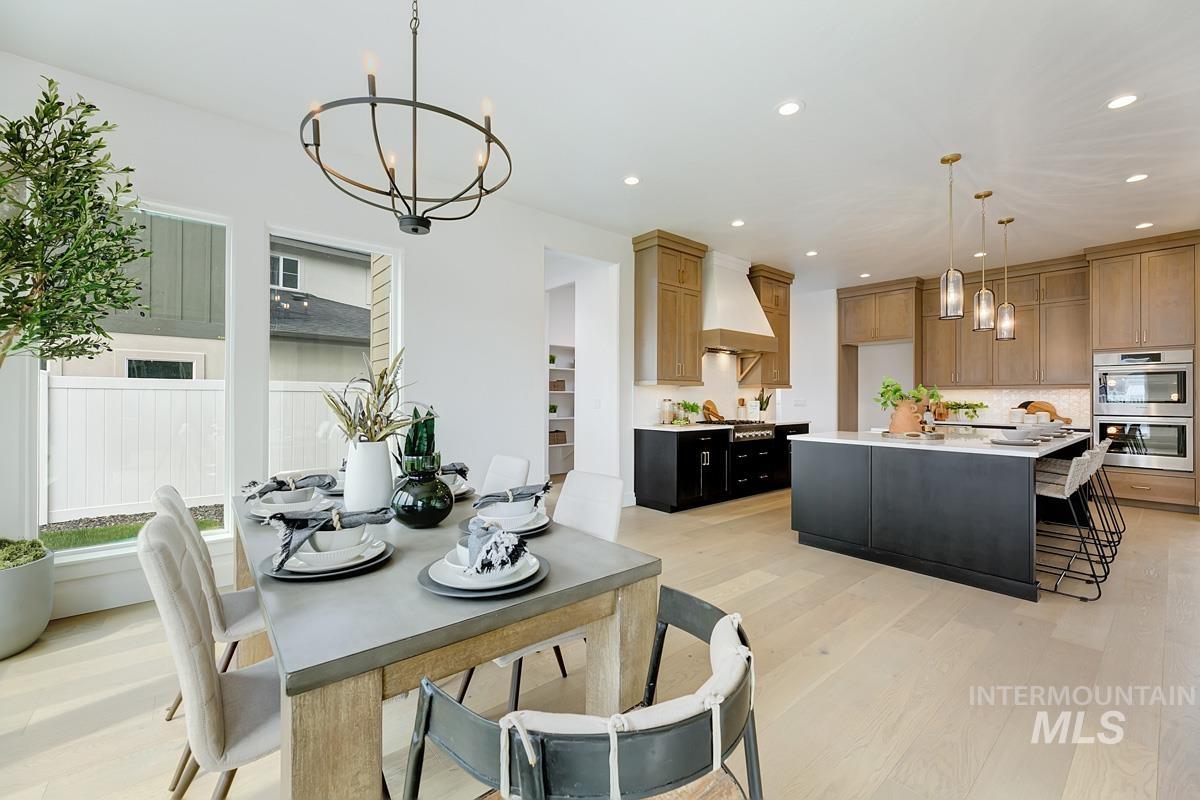 Dining space featuring a chandelier, light wood-type flooring, and recessed lighting