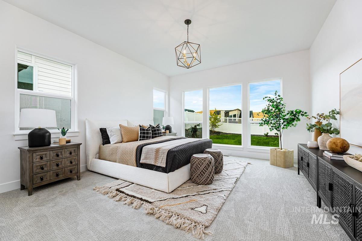 Bedroom featuring multiple windows and carpet
