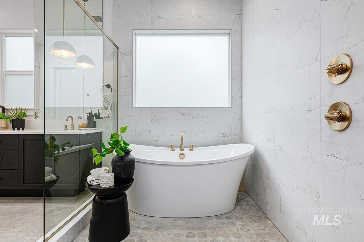 Full bath featuring vanity and a freestanding tub