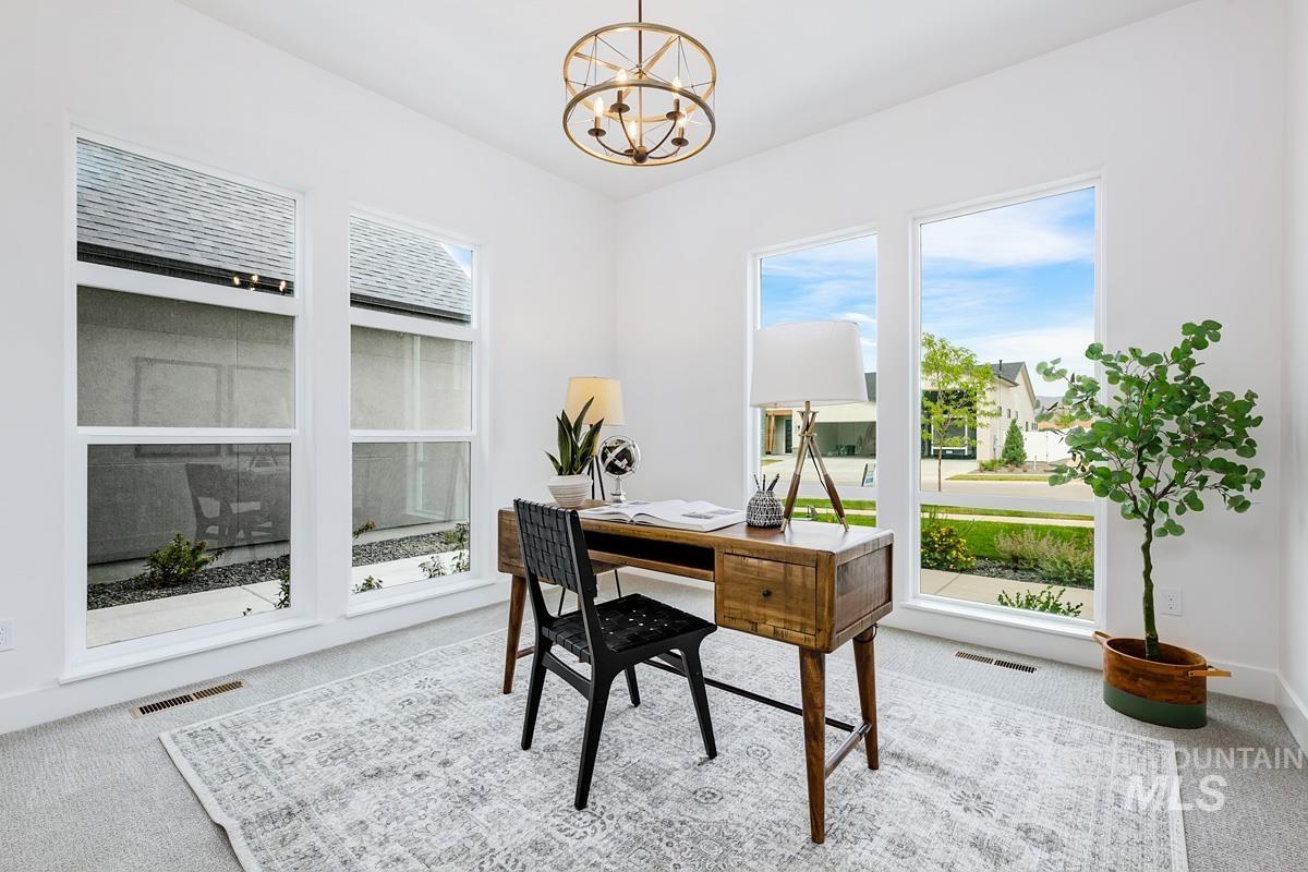 Office featuring carpet floors and a chandelier