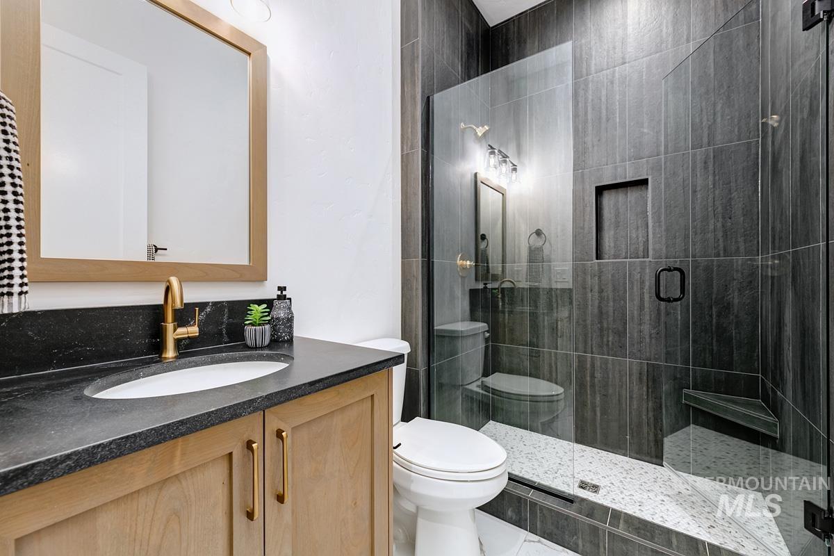 Bathroom with vanity and a stall shower