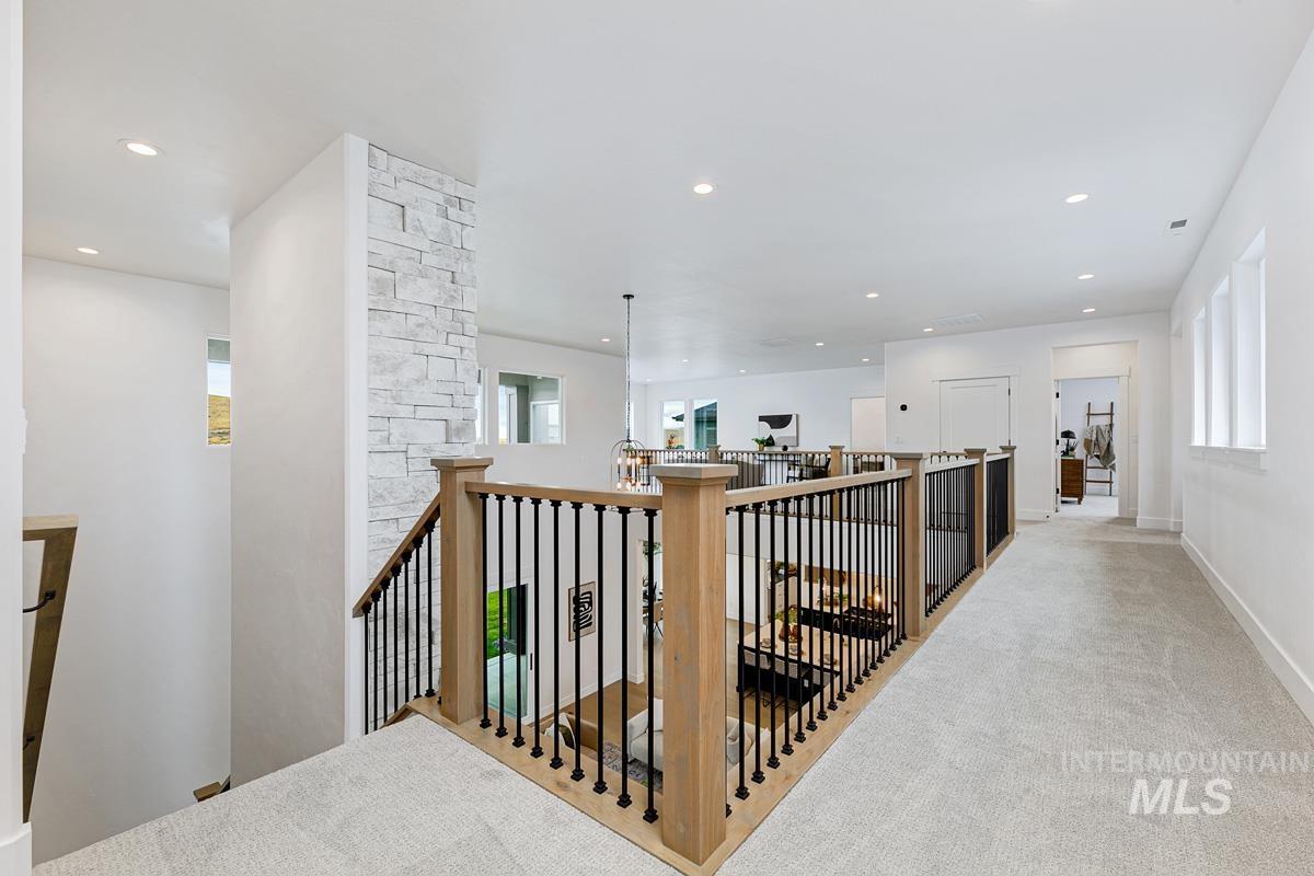 Corridor featuring an upstairs landing, recessed lighting, and carpet flooring