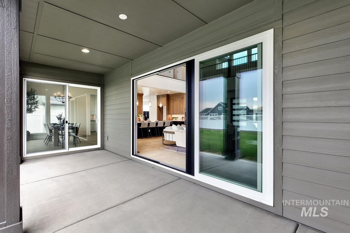 Doorway to property featuring a patio area