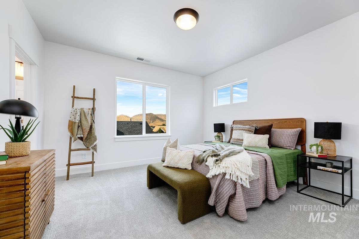 Carpeted bedroom with baseboards