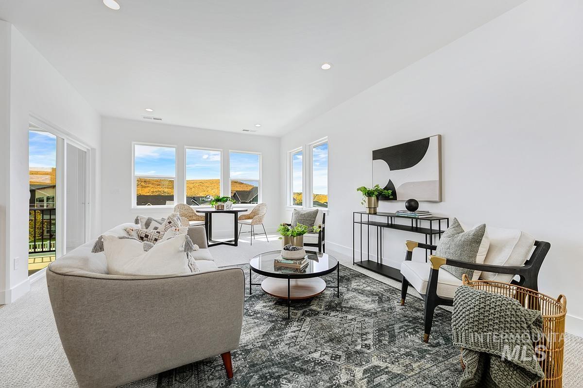 Carpeted living room with recessed lighting
