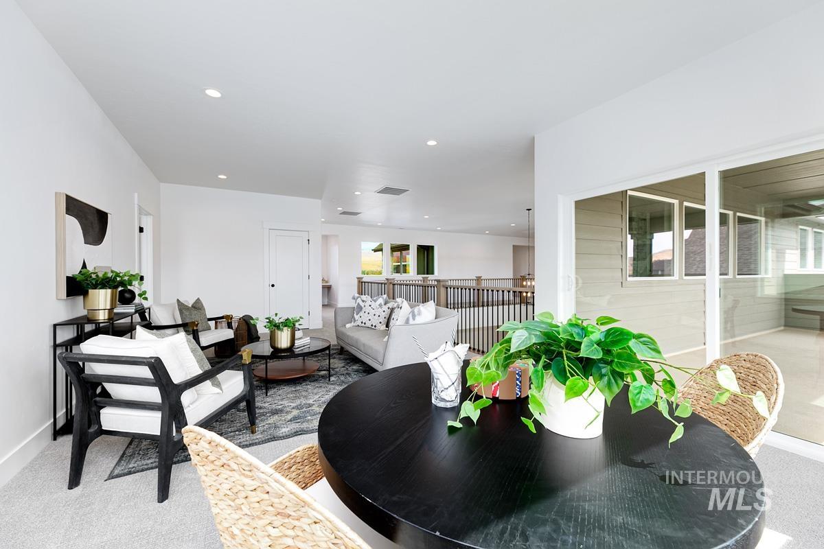 Dining room featuring light colored carpet and recessed lighting