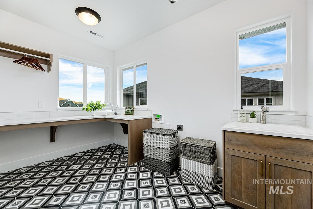 Office space with dark floors and a sink