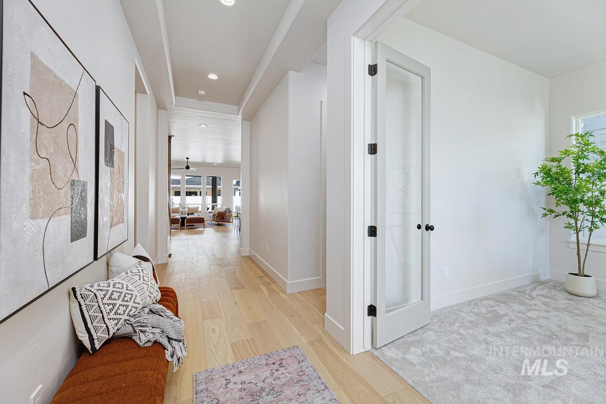 Hall featuring light wood-style floors and recessed lighting