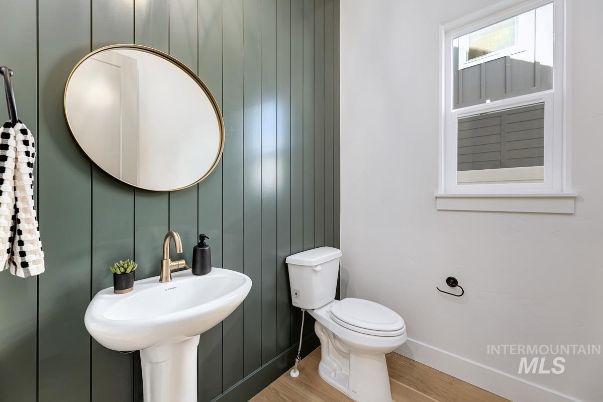 Bathroom with wood finished floors and wood walls