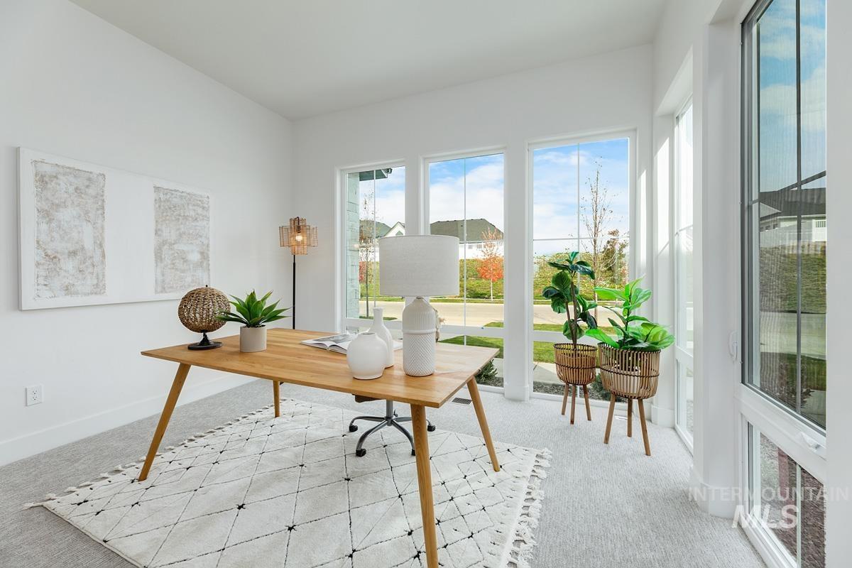 Carpeted office space with baseboards