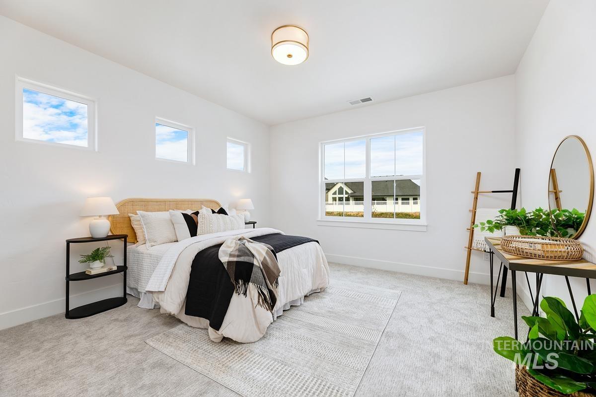Bedroom featuring light colored carpet