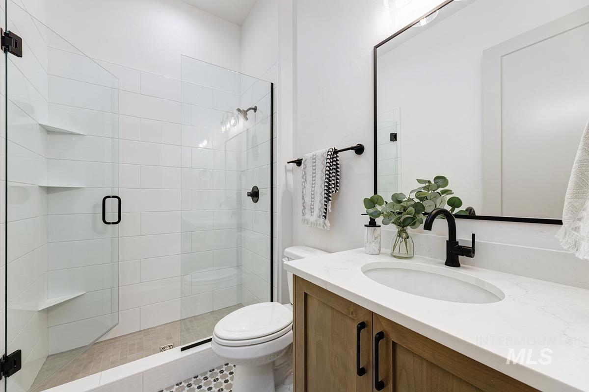 Full bathroom with vanity and a stall shower