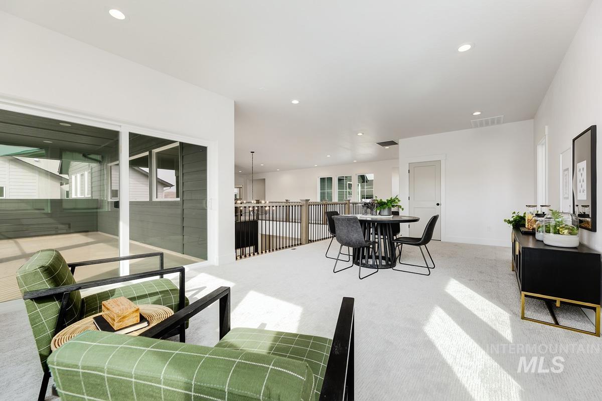 Living area featuring light carpet and recessed lighting