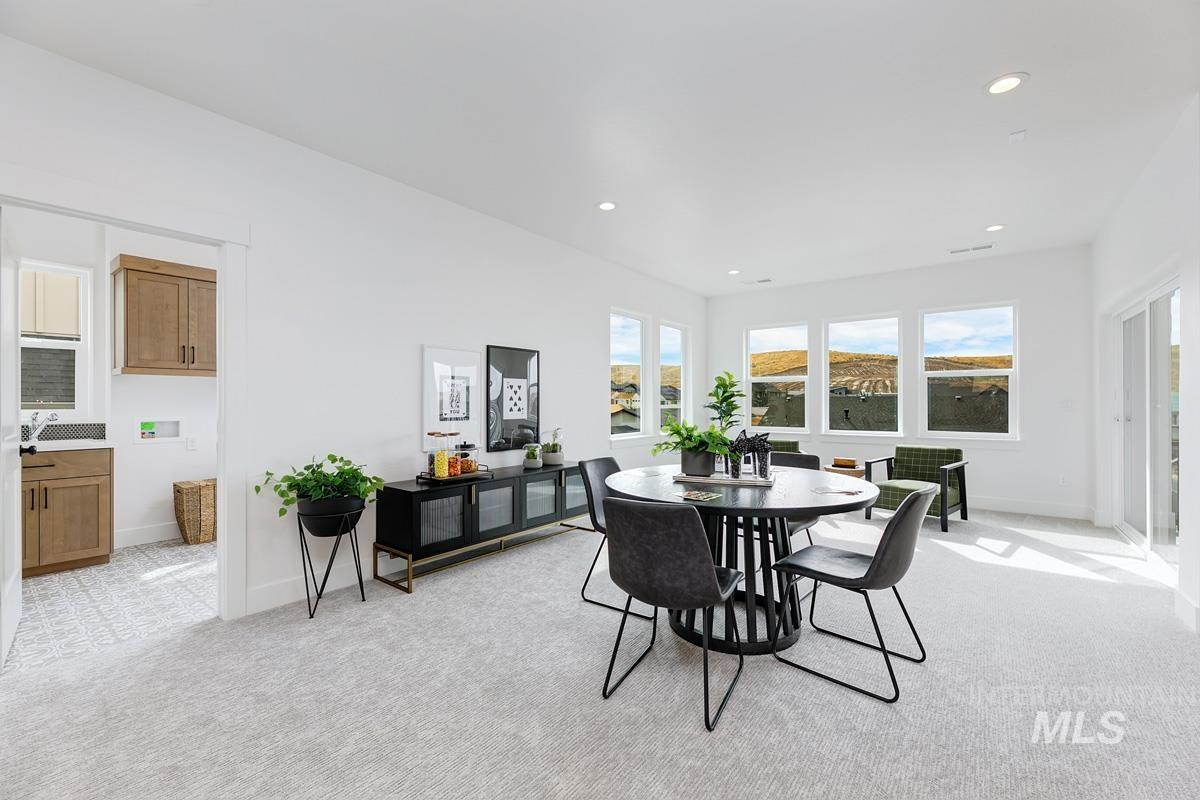Dining room featuring light colored carpet and recessed lighting