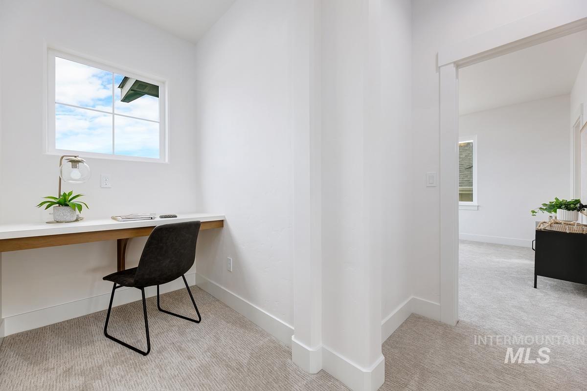 Office featuring light carpet and built in study area
