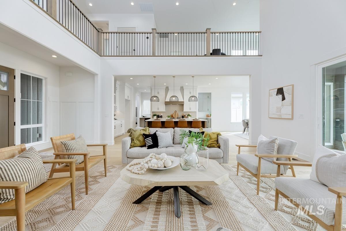 Living area featuring a towering ceiling and recessed lighting
