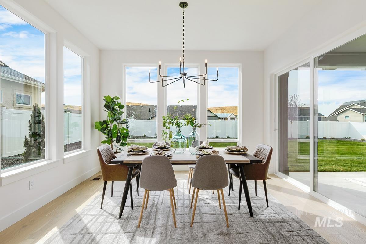 Dining room with a chandelier and light wood finished floors