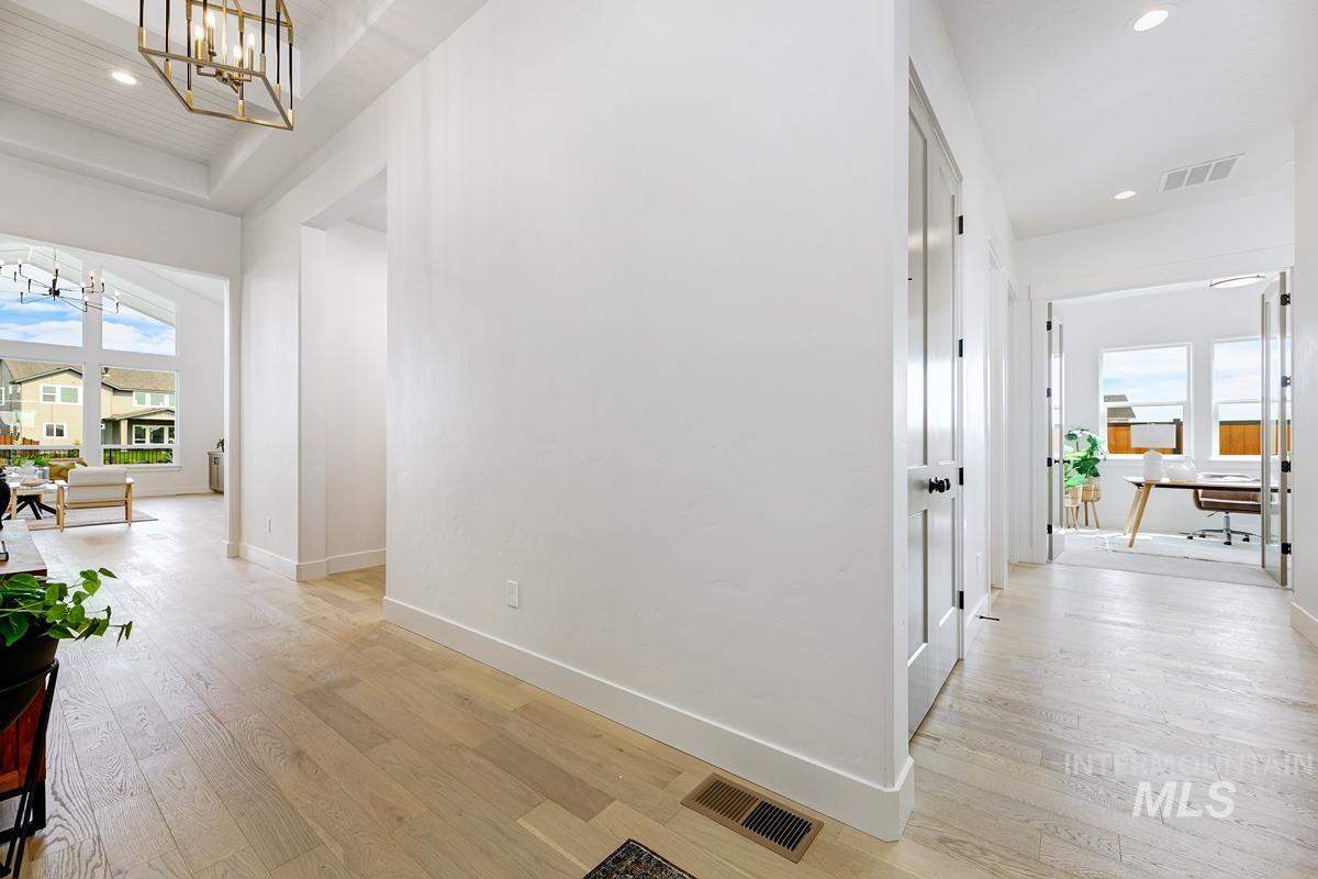 Hall with recessed lighting, light wood finished floors, a chandelier, and an office area