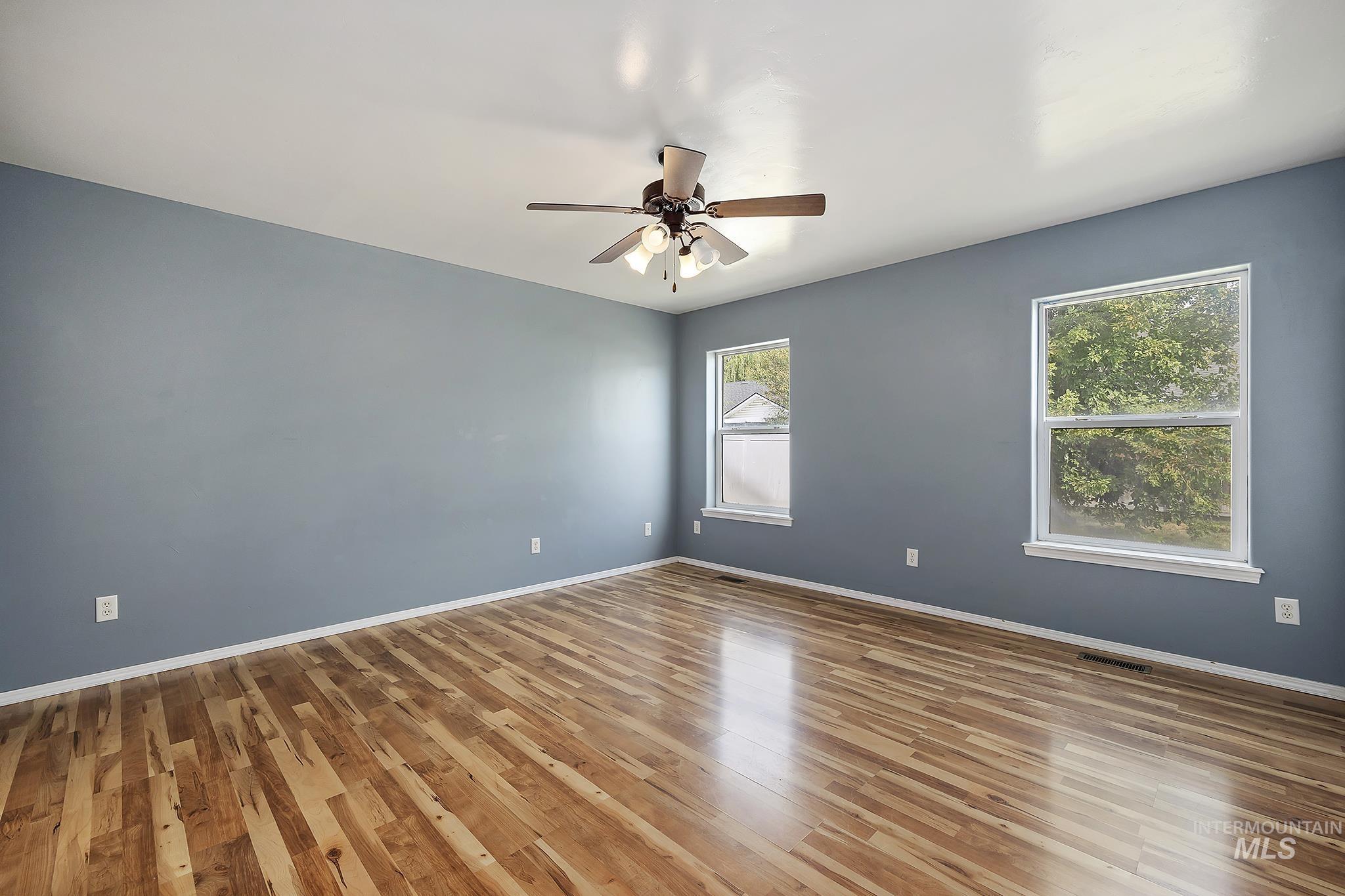 Spare room featuring wood finished floors and a ceiling fan