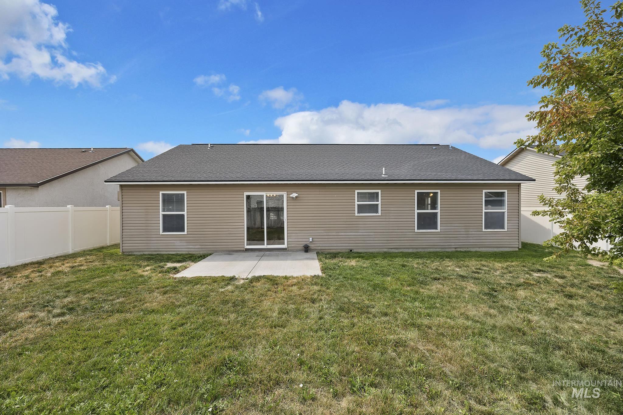 Back of house featuring a patio area, a shingled roof, and a fenced backyard