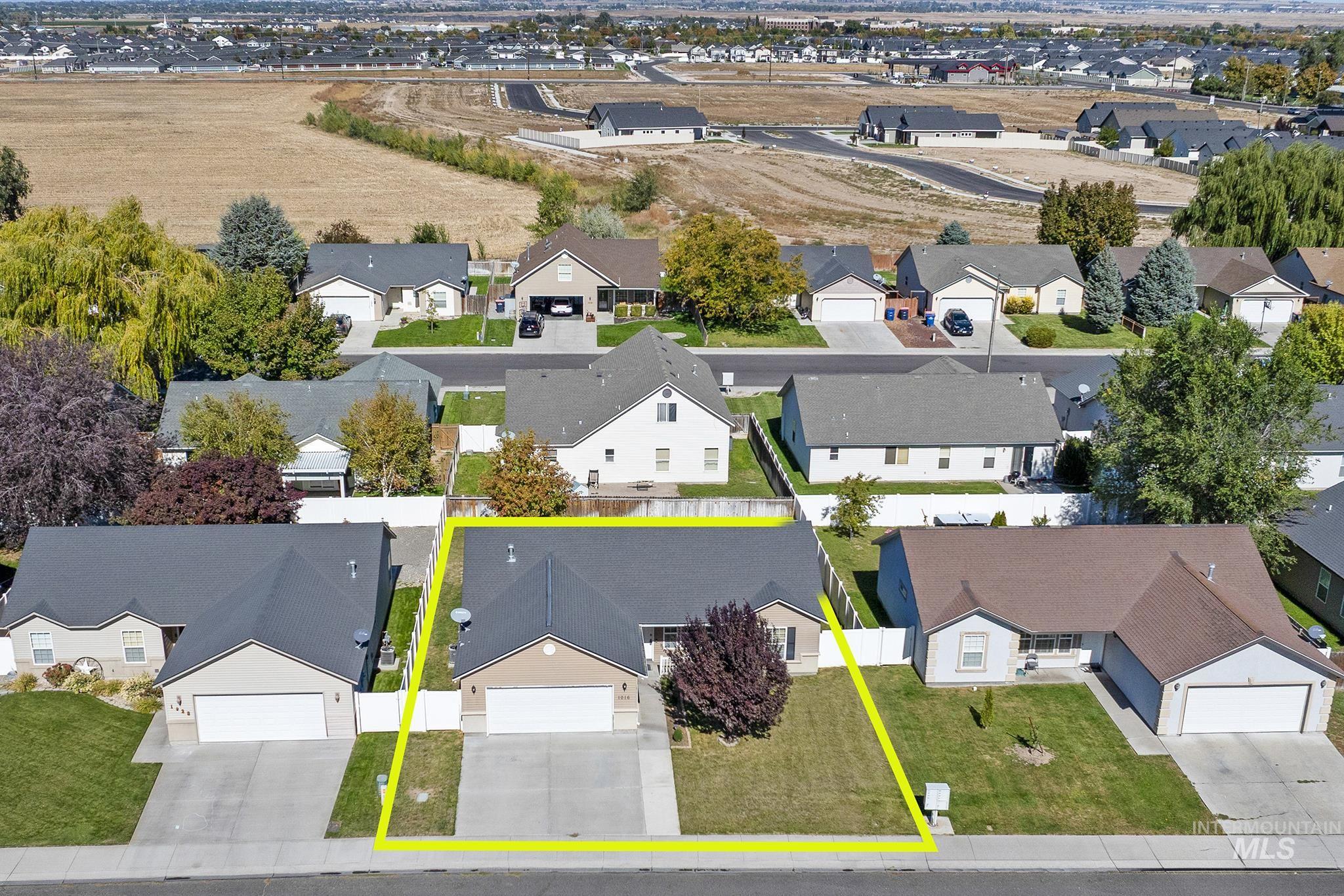 Aerial view of residential area with property parcel outlined
