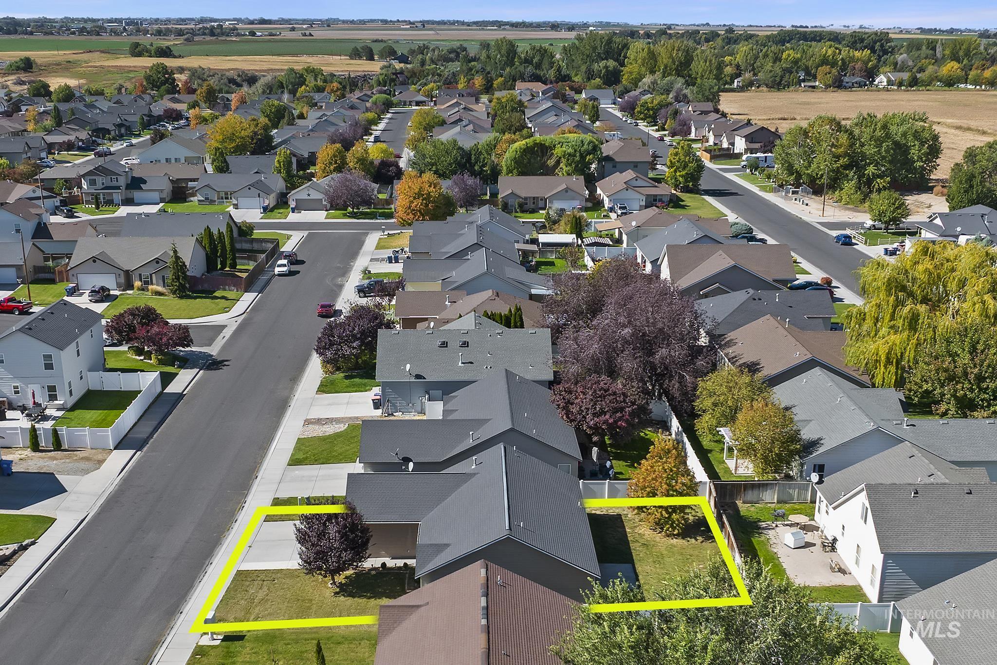 Aerial view of residential area featuring property boundaries highlighted