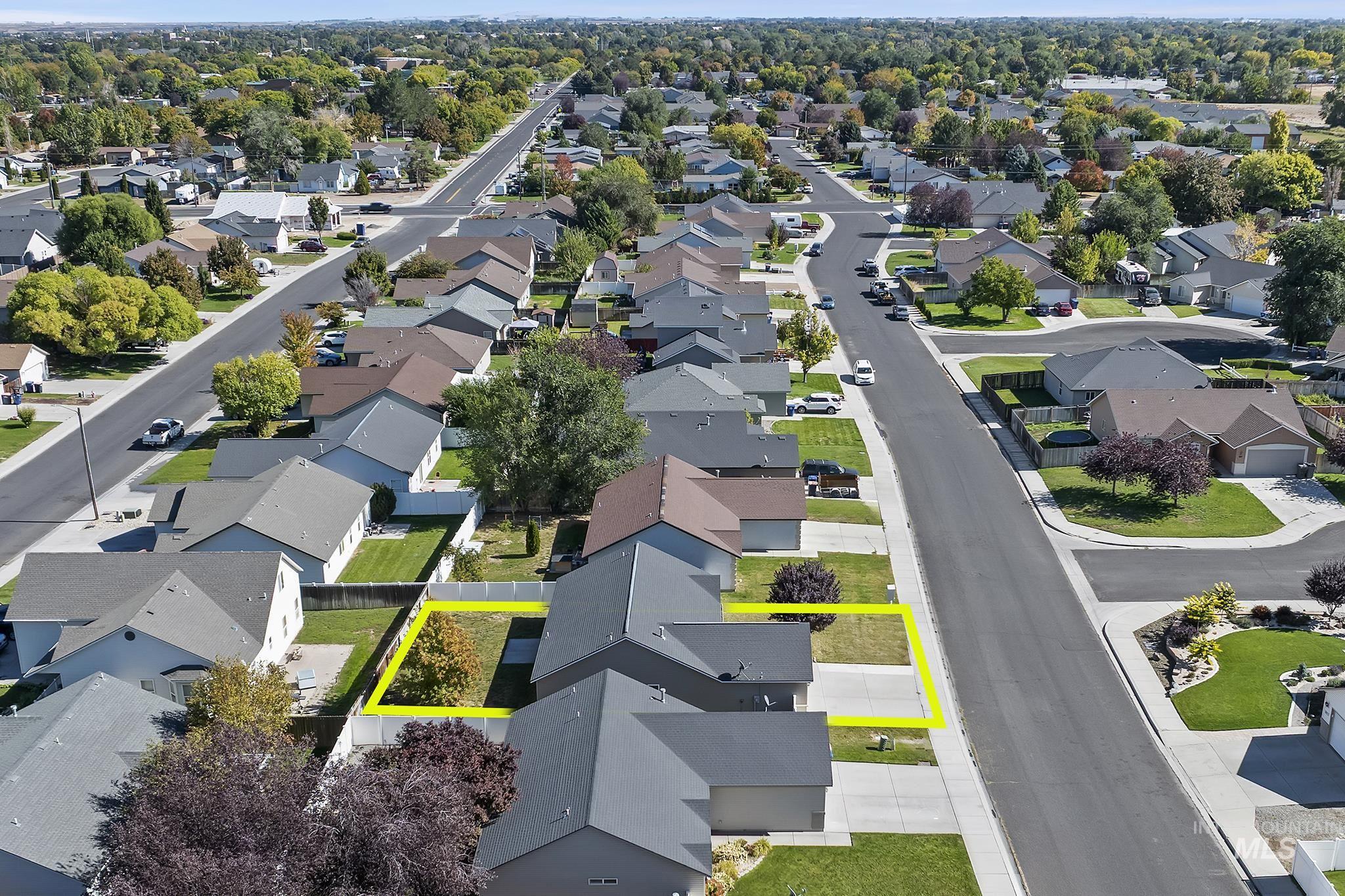 Aerial view of residential area with property parcel outlined