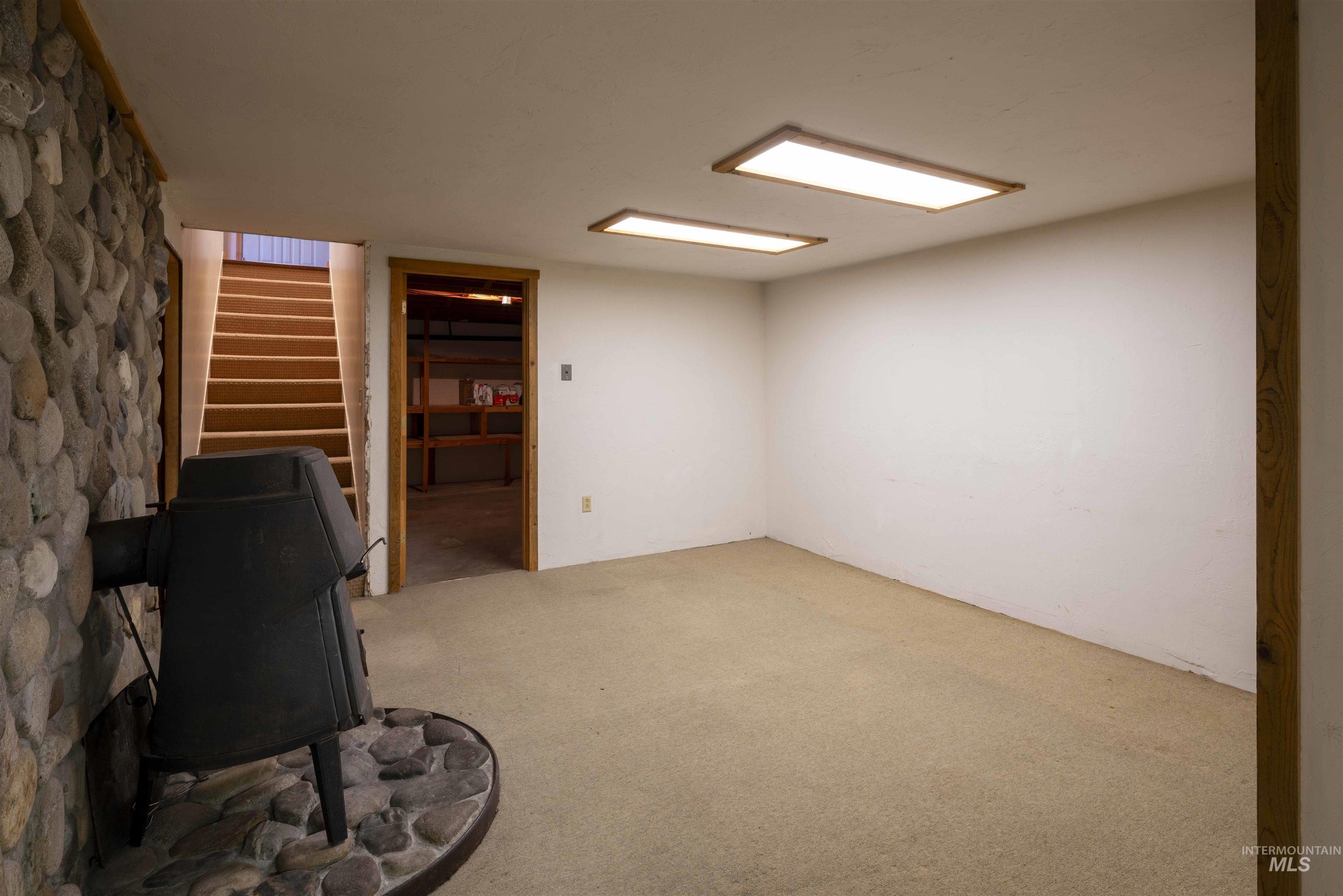 Finished basement featuring carpet flooring and stairs