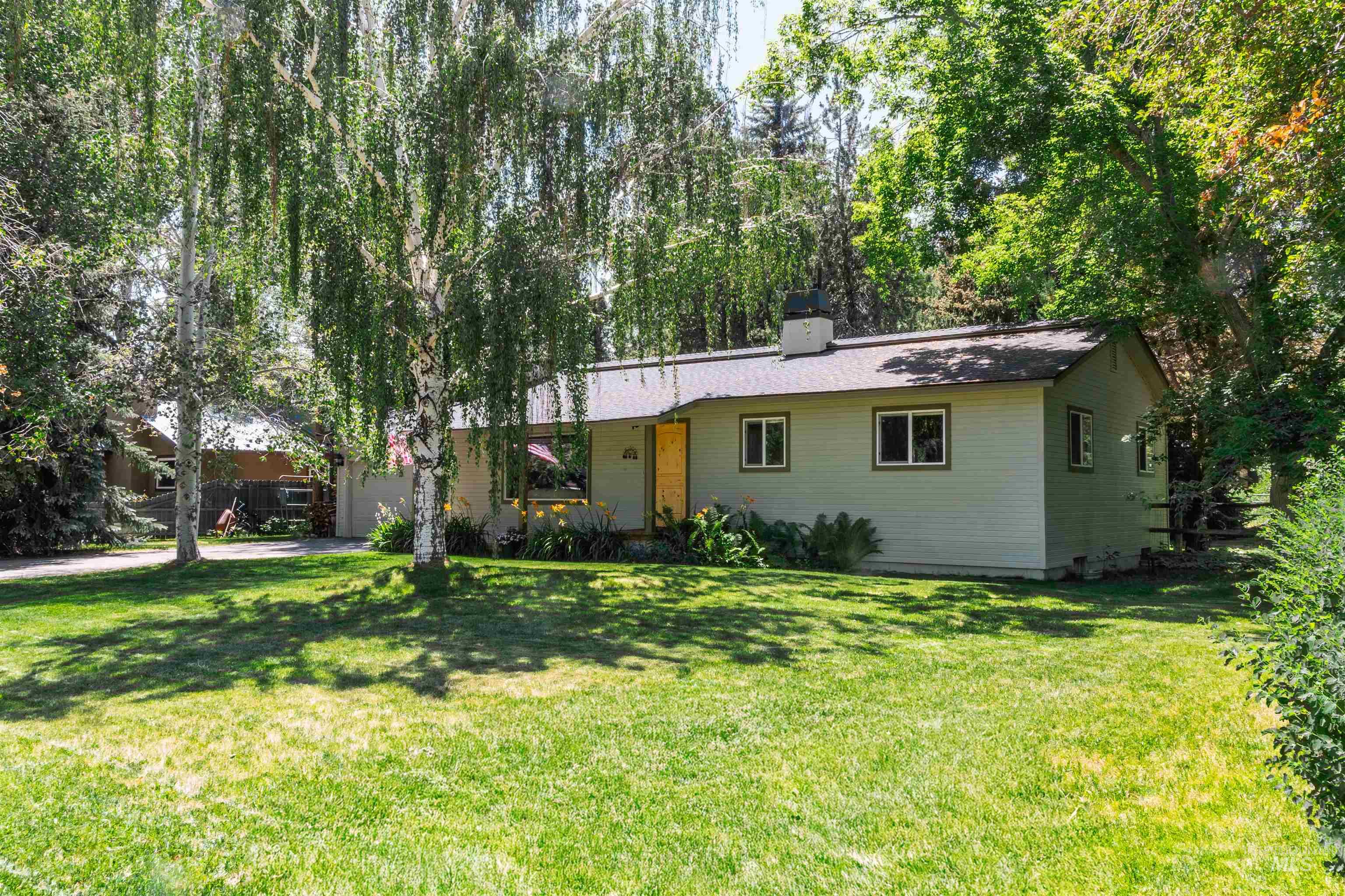 Ranch-style home with a front lawn and a chimney