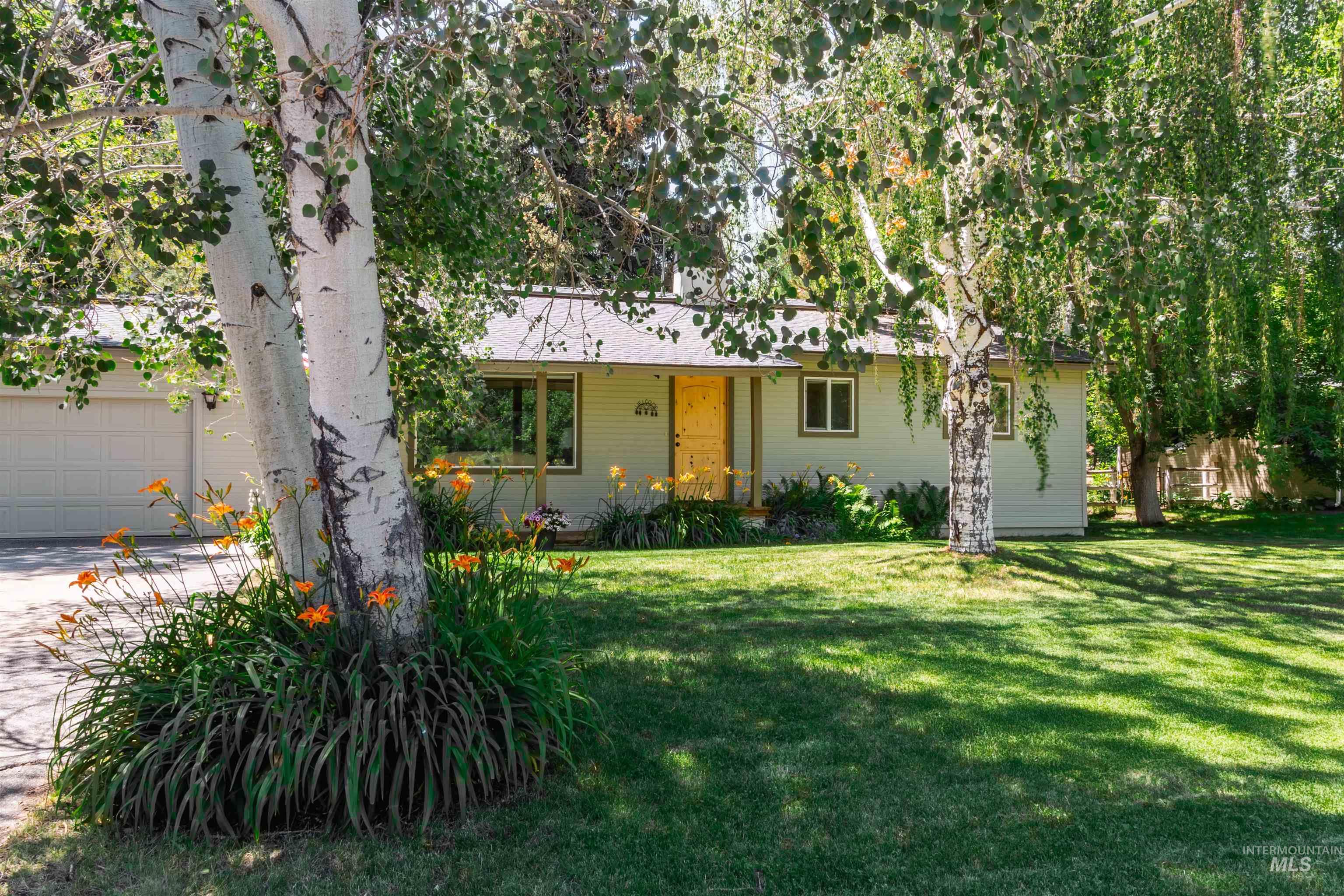 Ranch-style home with a front yard and a garage