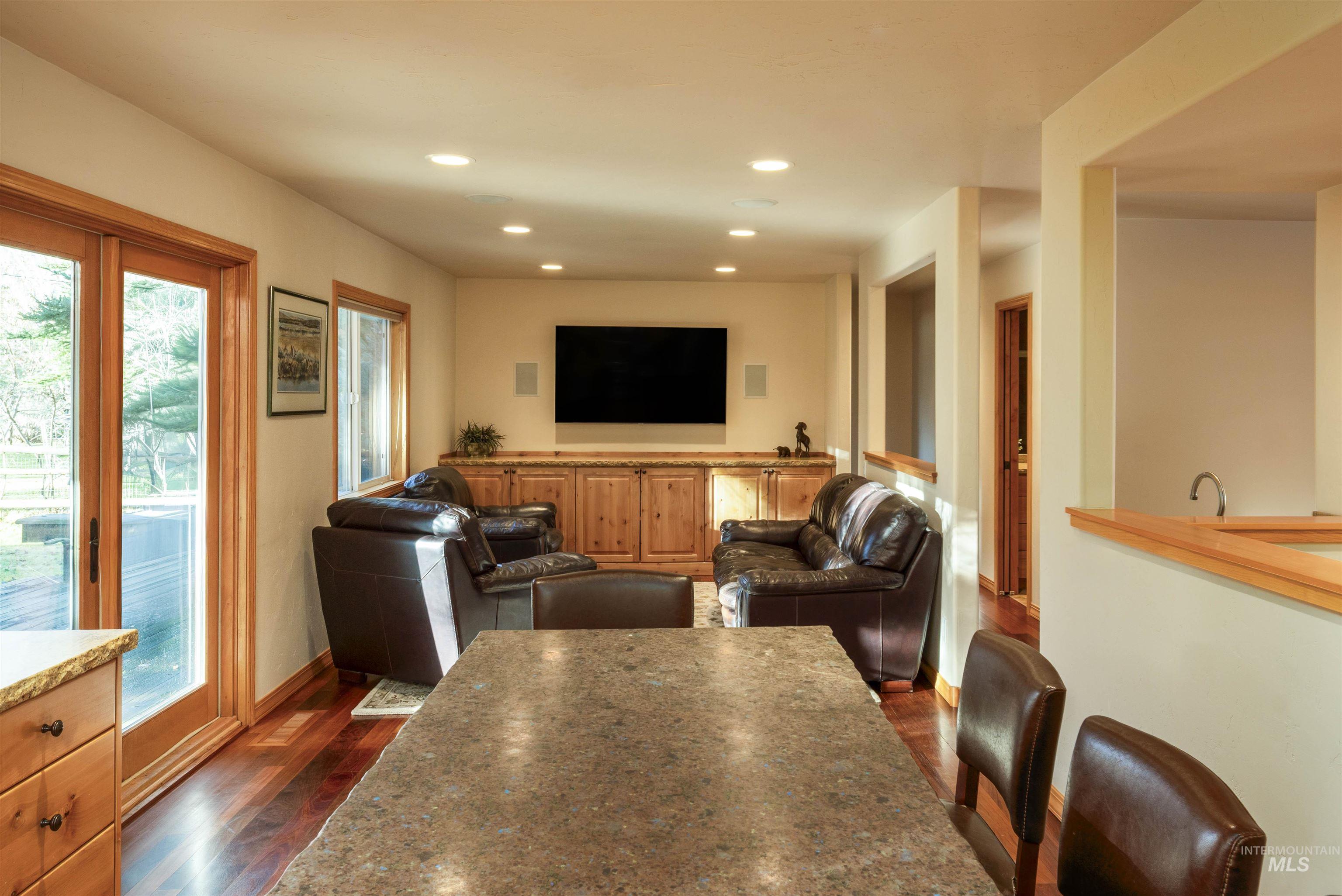 Dining space featuring recessed lighting and dark wood finished floors