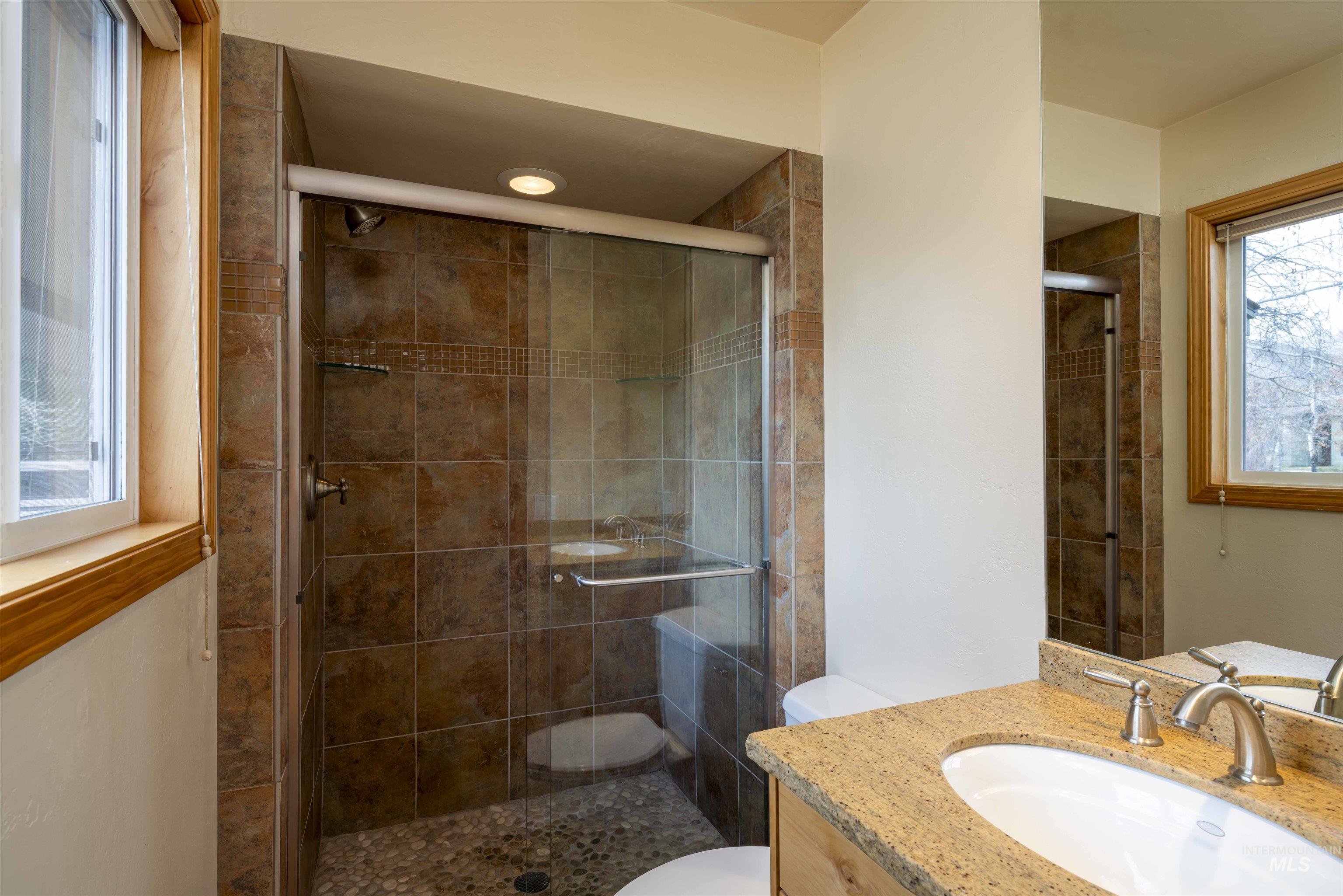 Full bathroom featuring vanity and a stall shower