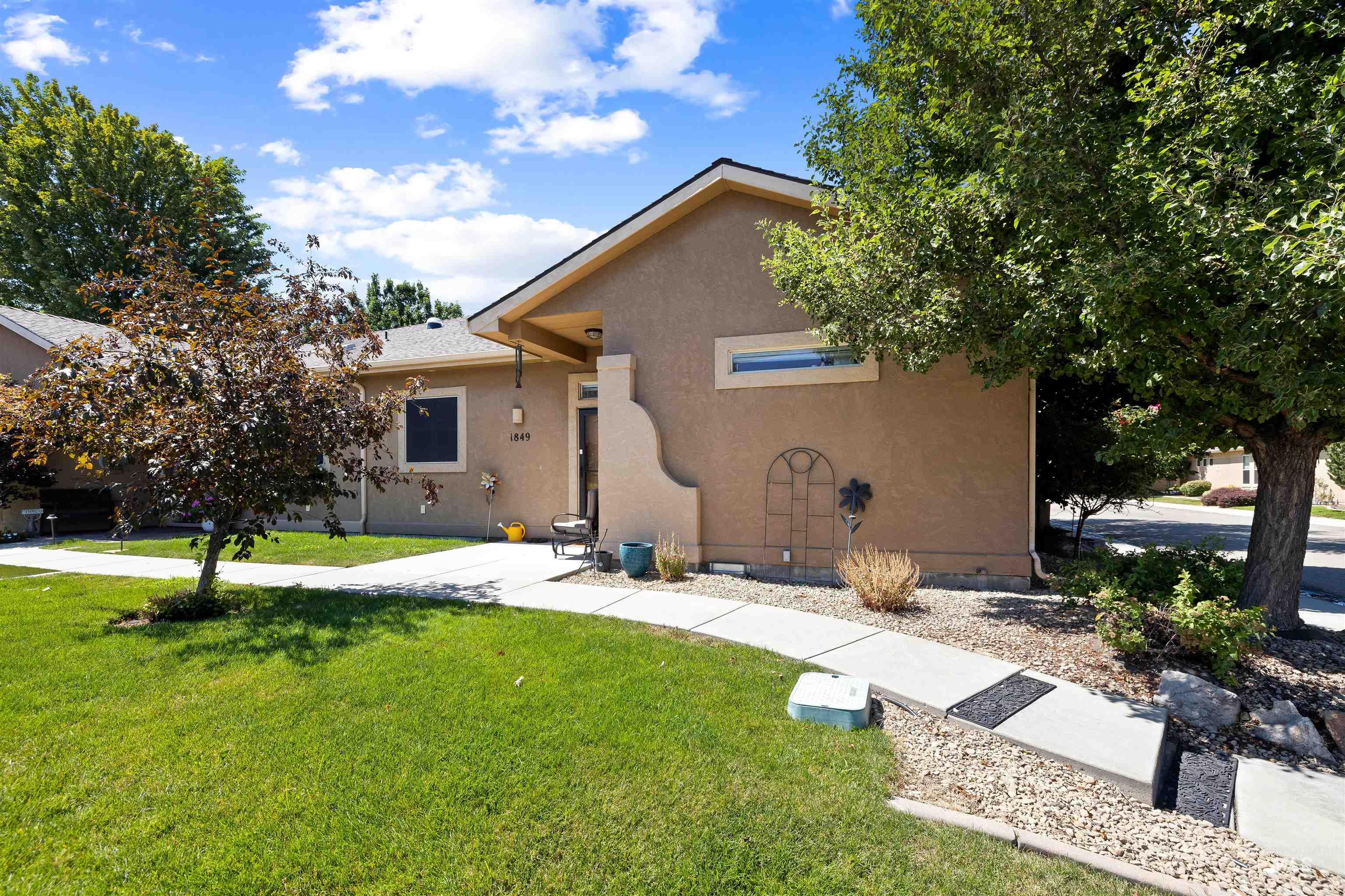 View of front of property with a front lawn and stucco siding
