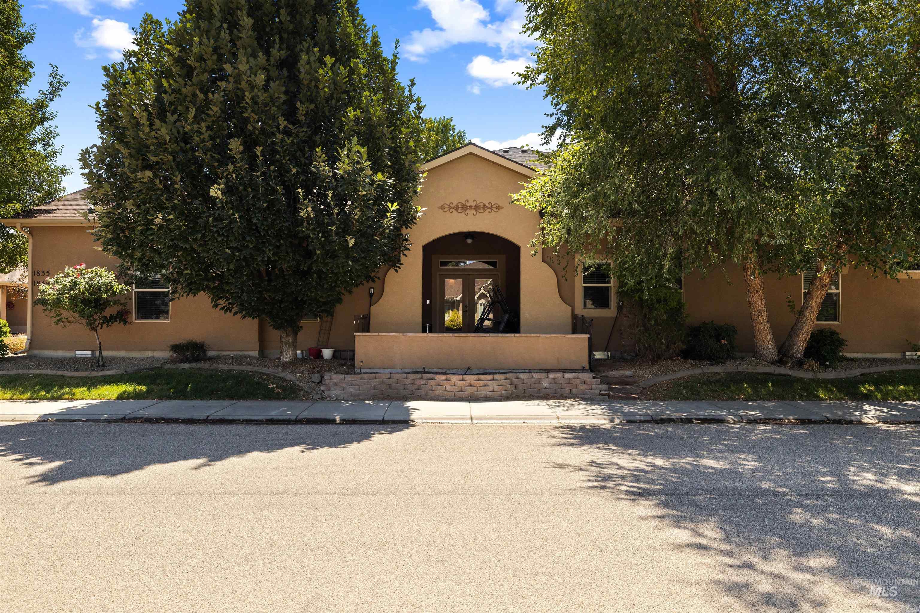 Obstructed view of property featuring stucco siding