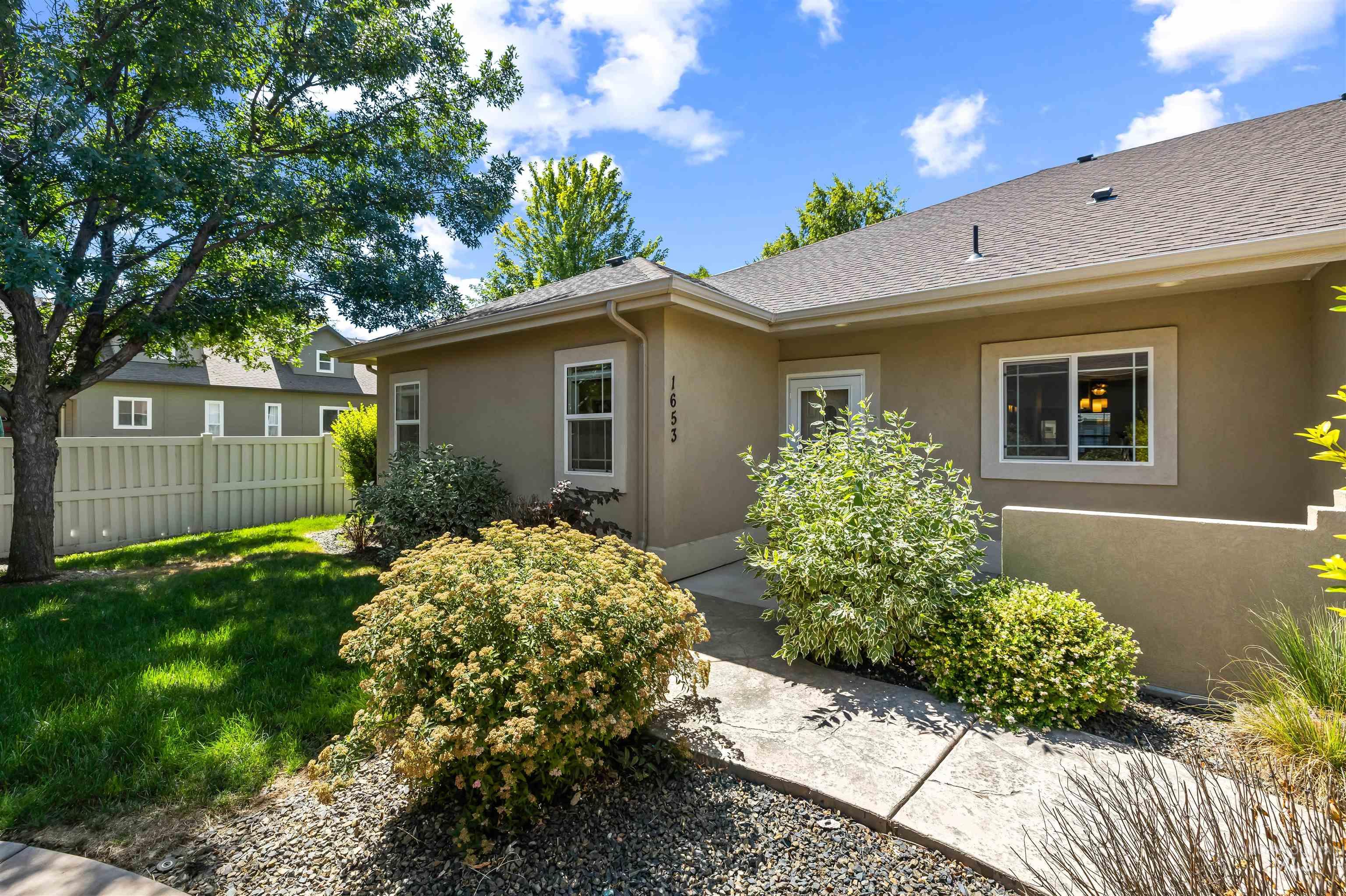 Entrance to property with stucco siding and roof with shingles