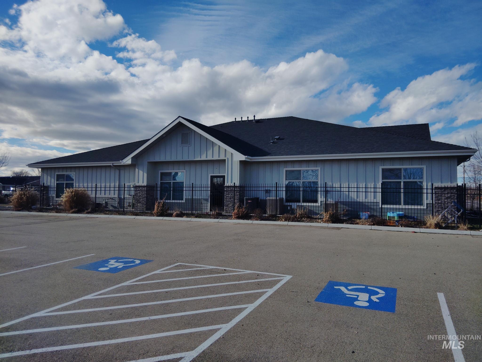 View of property with uncovered parking