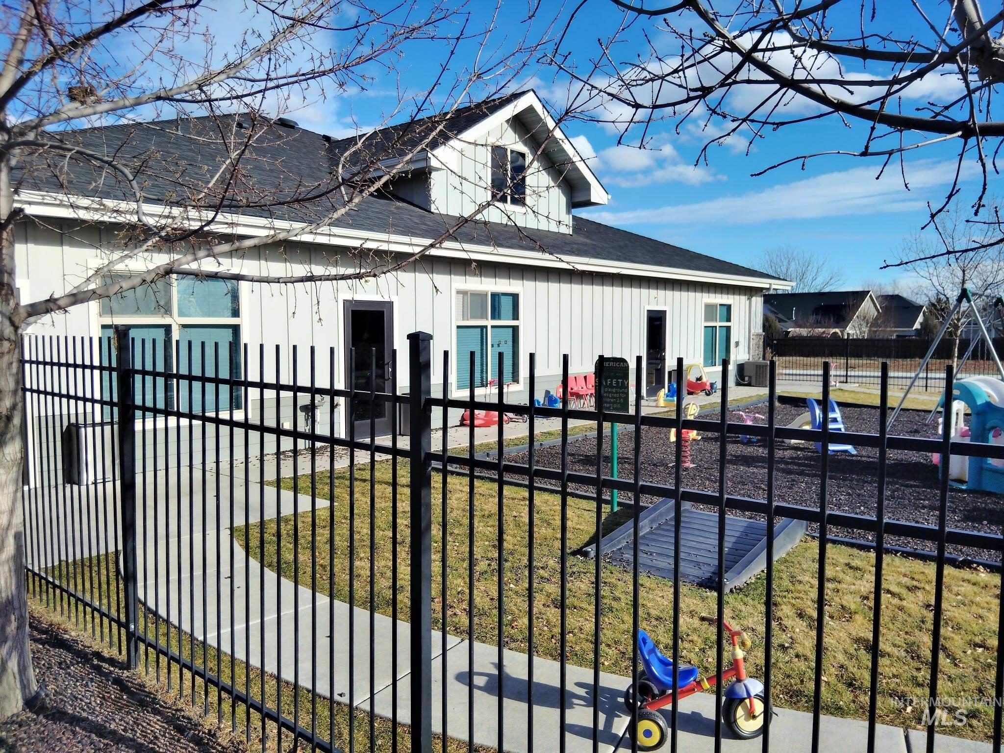 Back of property featuring board and batten siding and roof with shingles
