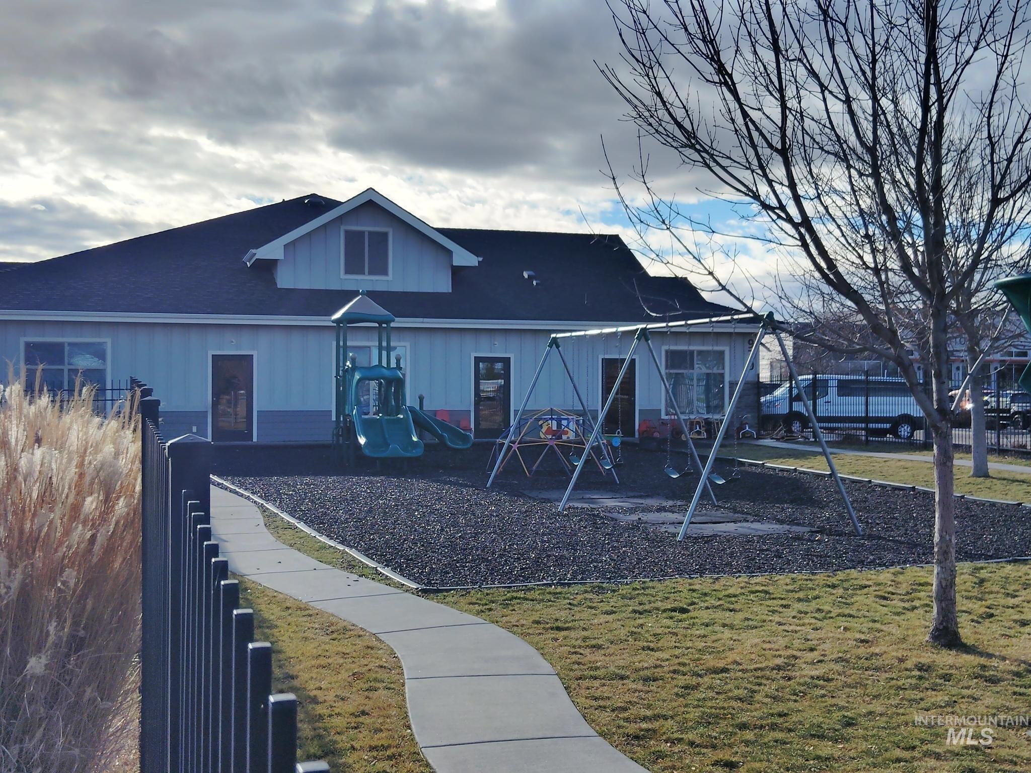 View of front of home with a playground and a front yard