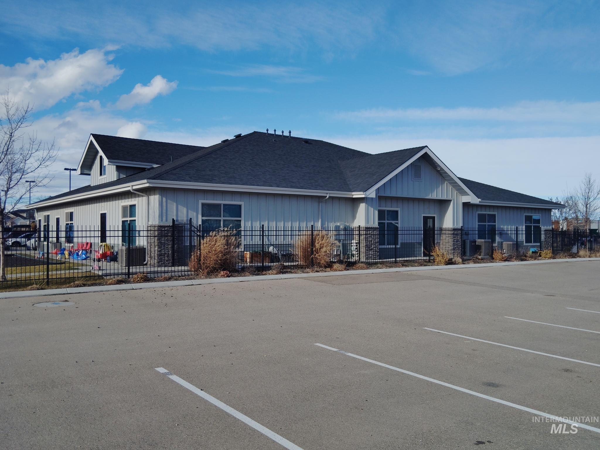 View of building exterior with uncovered parking