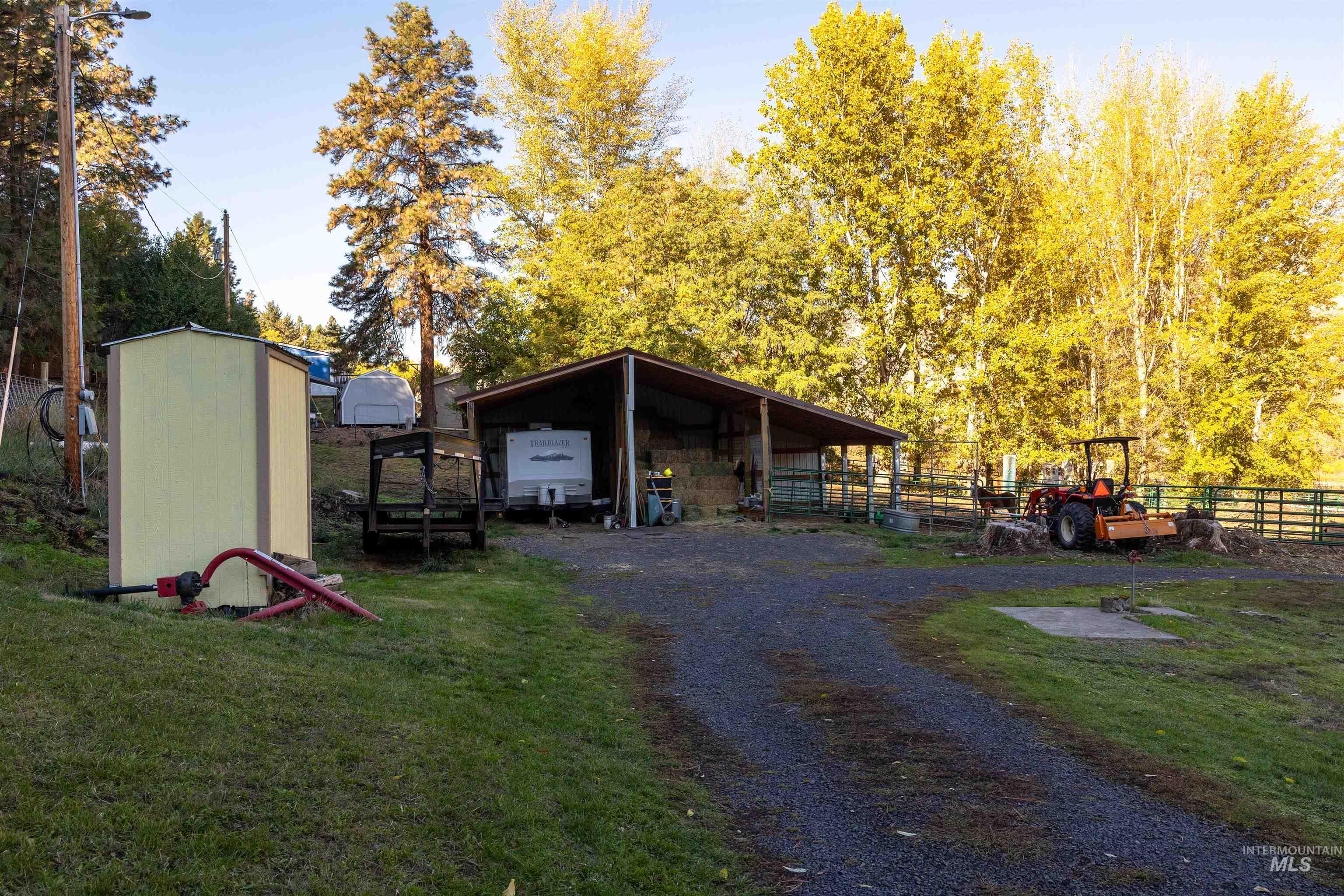 View of outbuilding featuring a carport and driveway