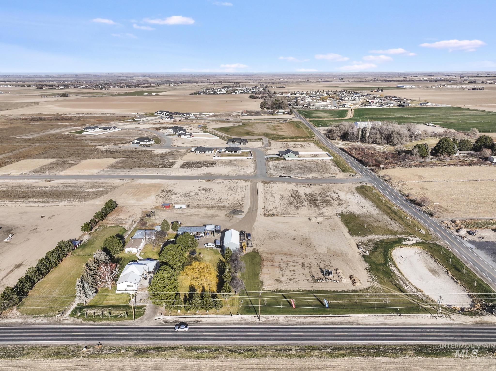 Aerial view of property and surrounding area featuring rural landscape