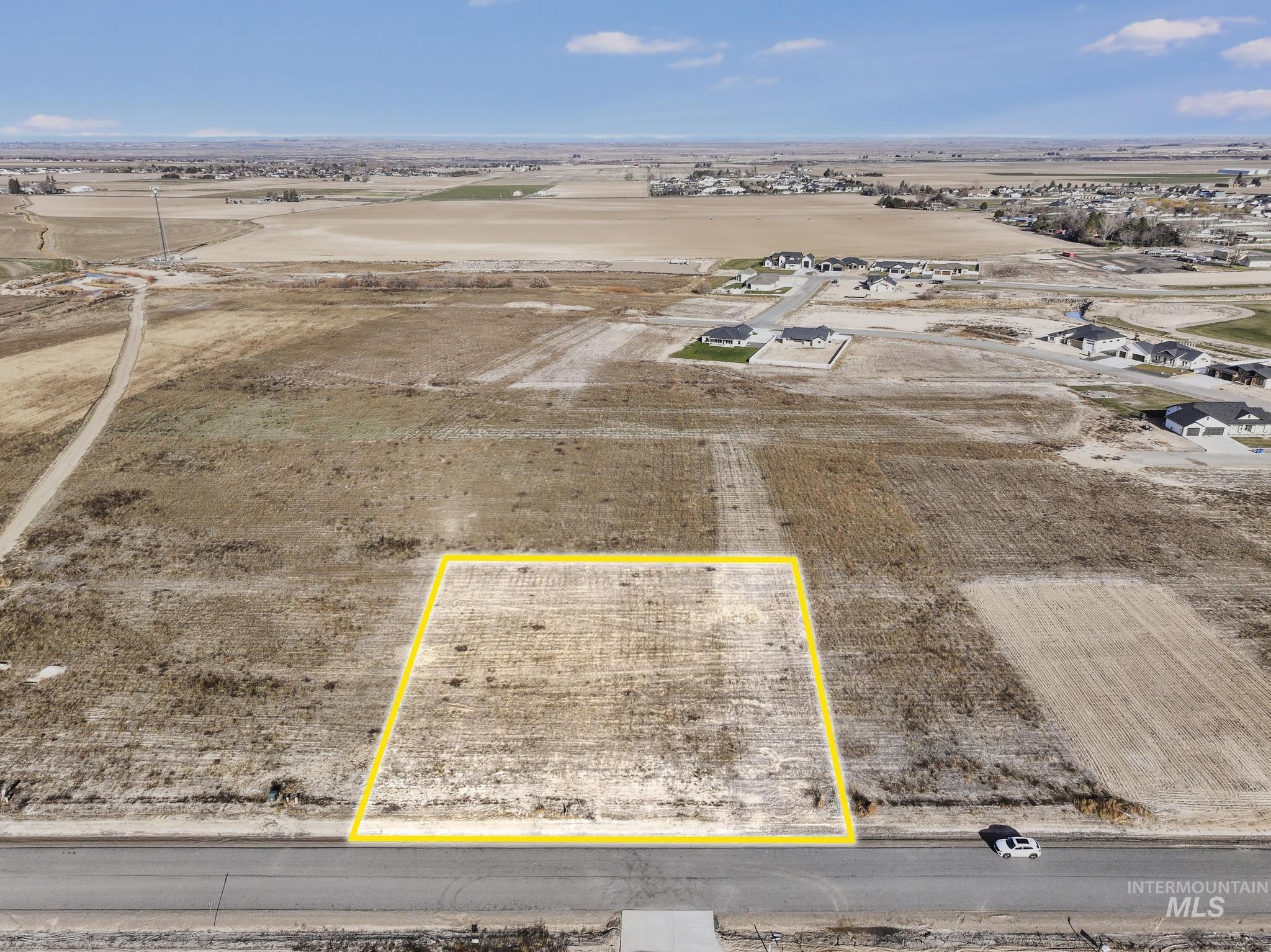 Aerial view of sparsely populated area with property boundaries highlighted