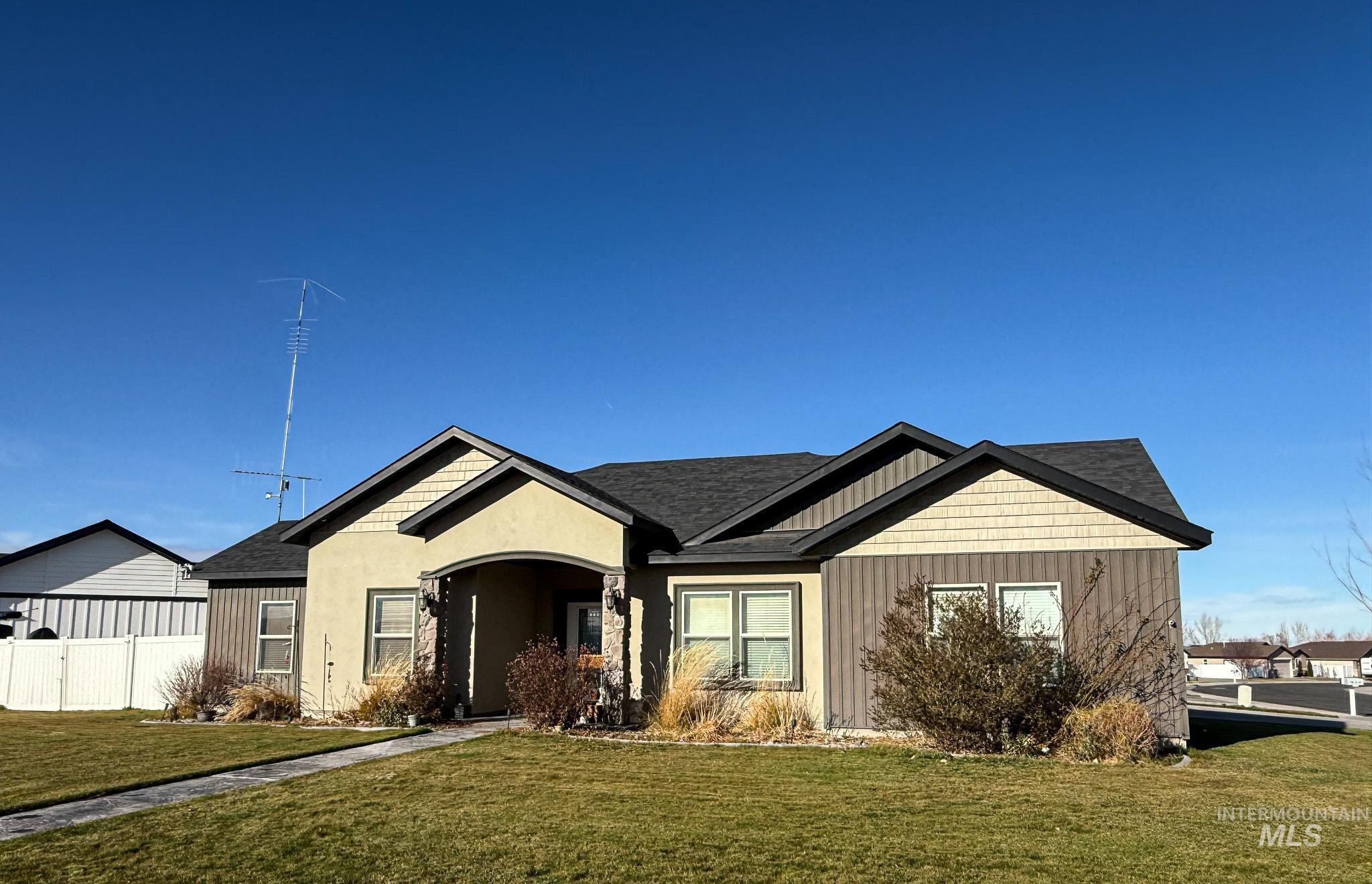 View of front of home featuring a shingled roof, stucco siding, and board and batten siding