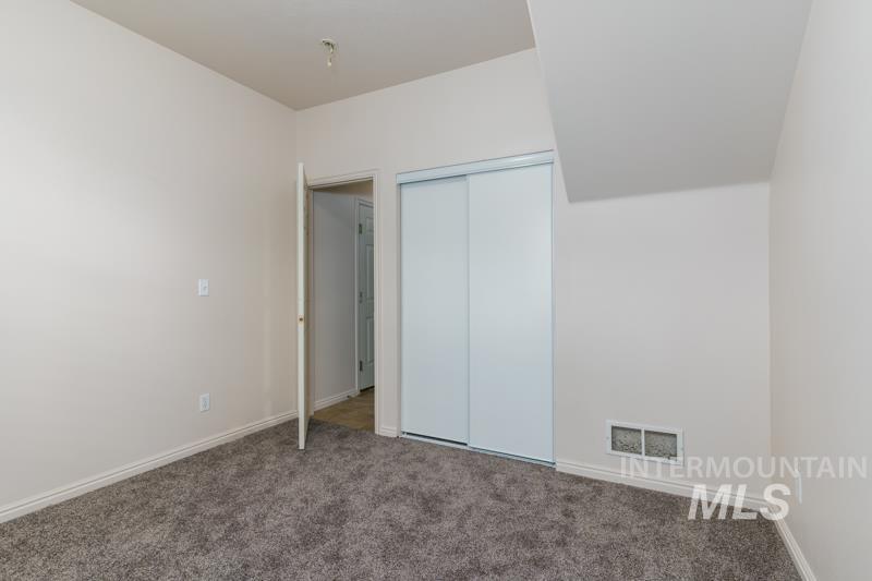 Unfurnished bedroom featuring carpet floors and a closet