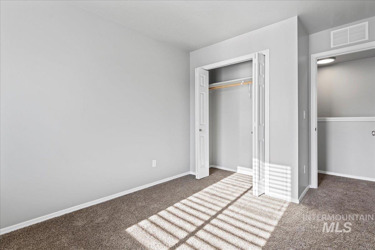Unfurnished bedroom with carpet and a closet
